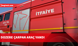 Haspolat’ta park halindeki dozere çarpan otomobil yandı