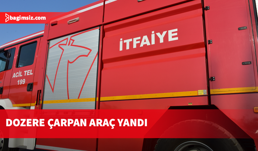 Haspolat’ta park halindeki dozere çarpan otomobil yandı